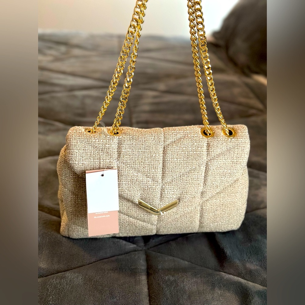 Large plush beige JustFab bag NWT. Plenty of space with gold hardware.